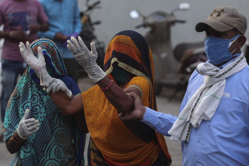 A relative of a patient who died of Covid-19 mourns outside a government hospital in Ahmedabad, India. Photo: AP