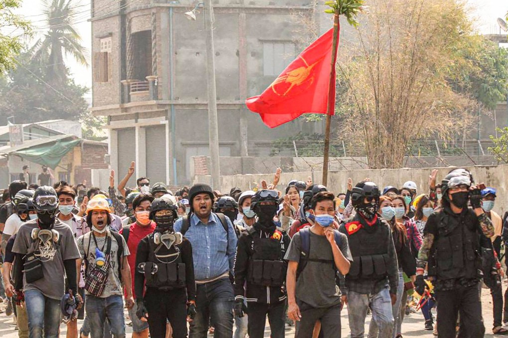 Wai Moe Naing (in blue) walks with protesters during a rally against the military coup in Monywa. Photo: Facebook / AFP