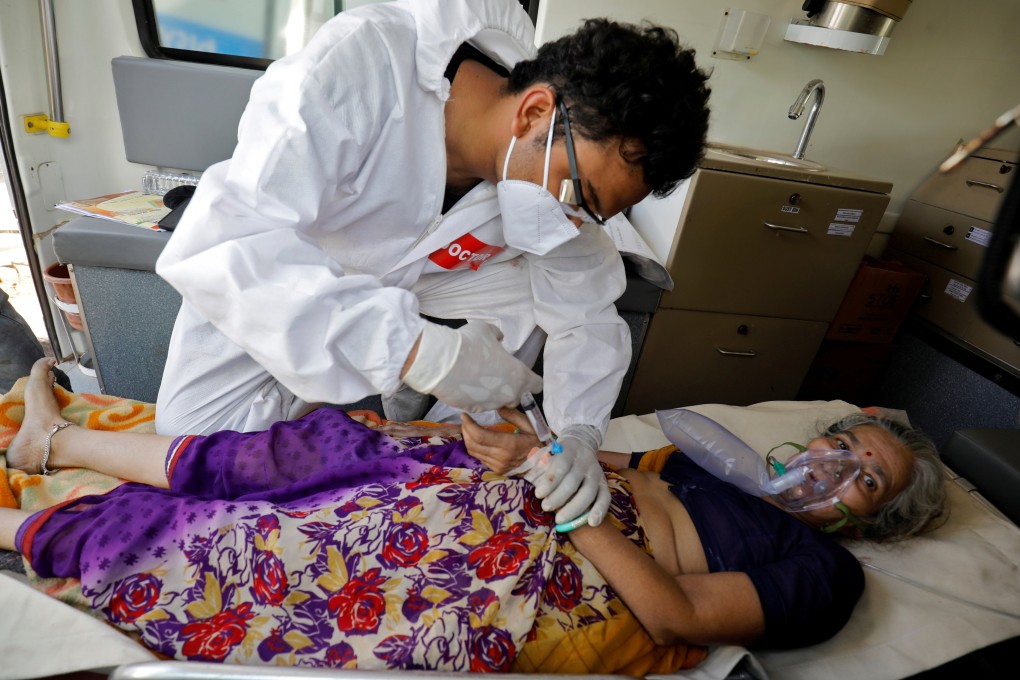 A doctor tends to a patient with a breathing problem in Ahmedabad, India. Photo: Reuters