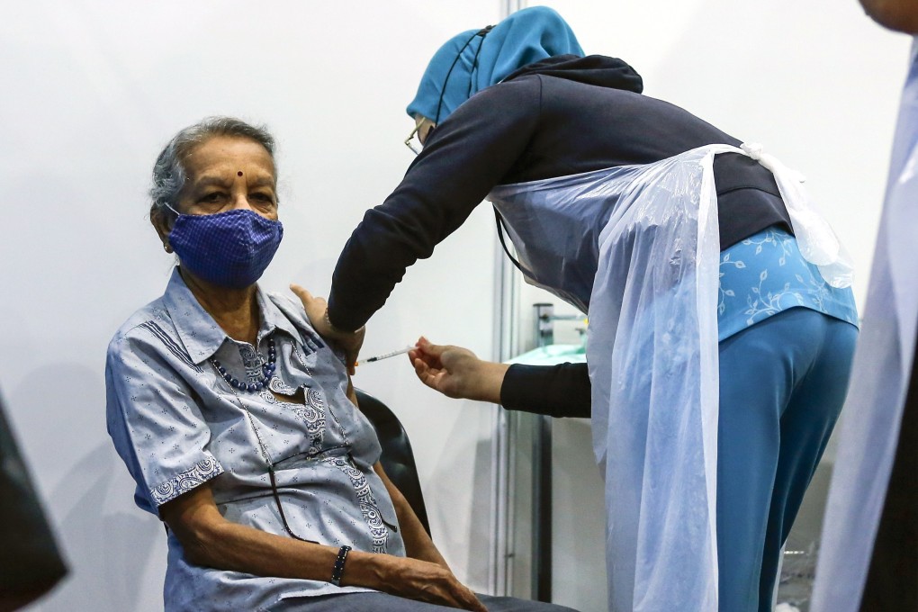 An elderly woman receives a Pfizer-BioNTech coronavirus vaccine shot in Malaysia. Photo: EPA-EFE