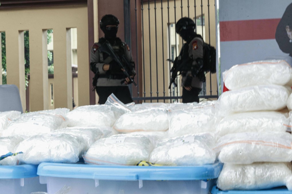 Police guard bags of seized methamphetamine during a press conference in Jakarta on April 28, 2021. Photo: AFP
