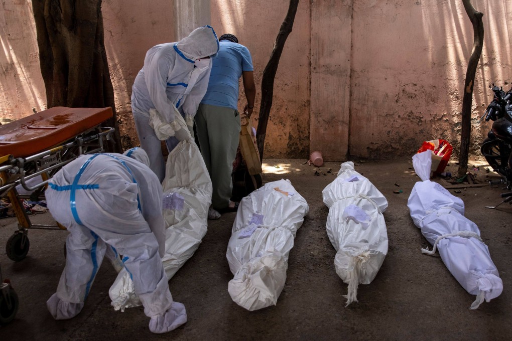 Healthcare workers transport the body of a person who died of Covid-19 at a cremation ground in New Delhi on Wednesday. Photo: Reuters