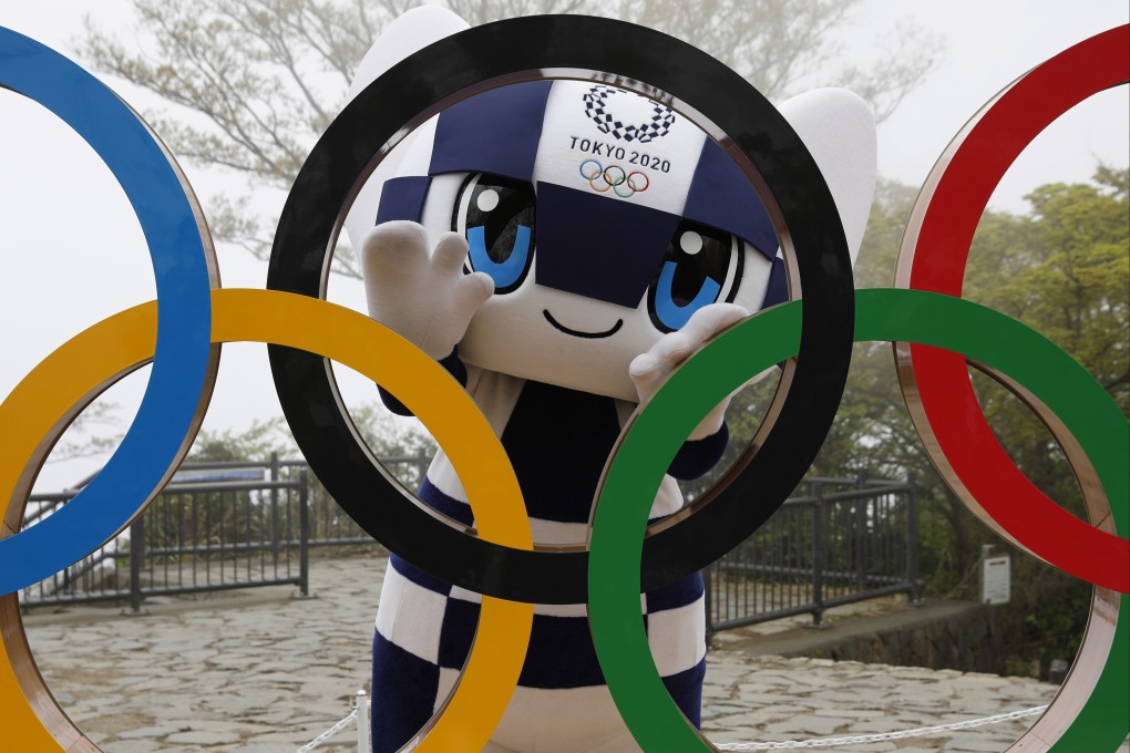 Tokyo Olympic Games mascot Miraitowa poses with a display of the Olympic rings after an unveiling ceremony on Mount Takao in Hachioji to mark 100 days before the Games start. Photo: AP