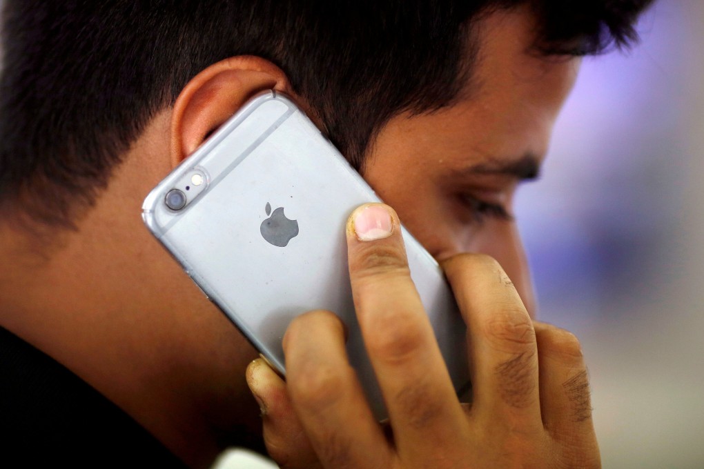 A man talks on his iPhone at a mobile phone store in New Delhi, India, on July 27, 2016. Photo: Reuters