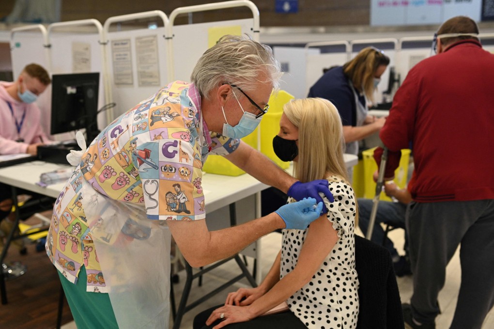 A health worker administers a dose of the Pfizer Covid-19 vaccine at Pride Park in Derby, Britain. Photo: AFP