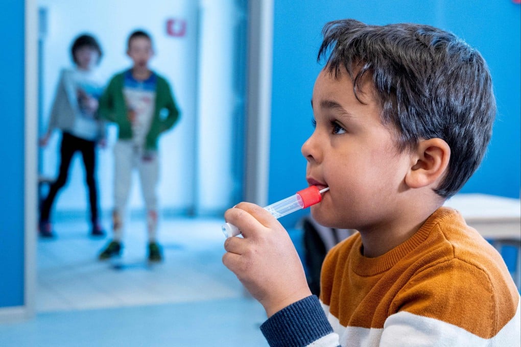 A pre-school boy uses a newly developed lollipop-shaped Covid-19 test in Vienna on Thursday. Photo: AFP