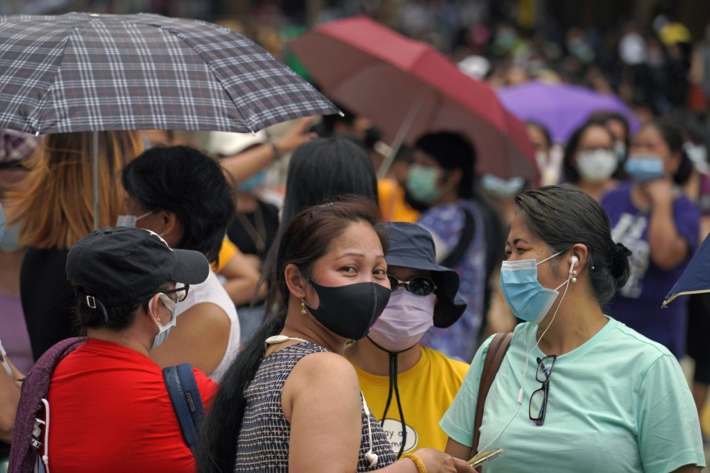 Filipino migrant workers queue up for Covid-19 tests in Hong Kong. Photo: AP