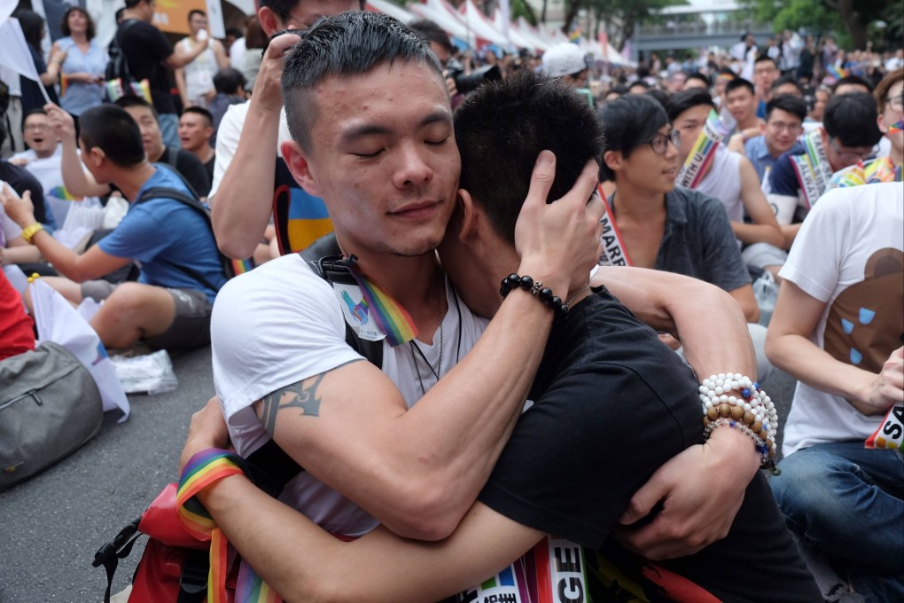 Same-sex activists hug outside the parliament in Taipei in 2017 as they celebrate the landmark decision paving the way for the island to become the first place in Asia to legalise gay marriage. The rest of China has yet to follow suit, and prejudice against same-sex couples persists in some quarters. Photo: AFP