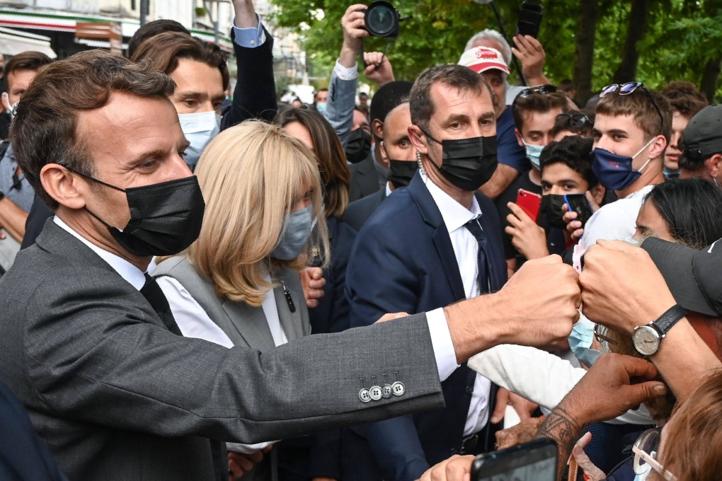 French President Emmanuel Macron (left) interacts with members of a crowd in Valence on Tuesday. Photo: AFP