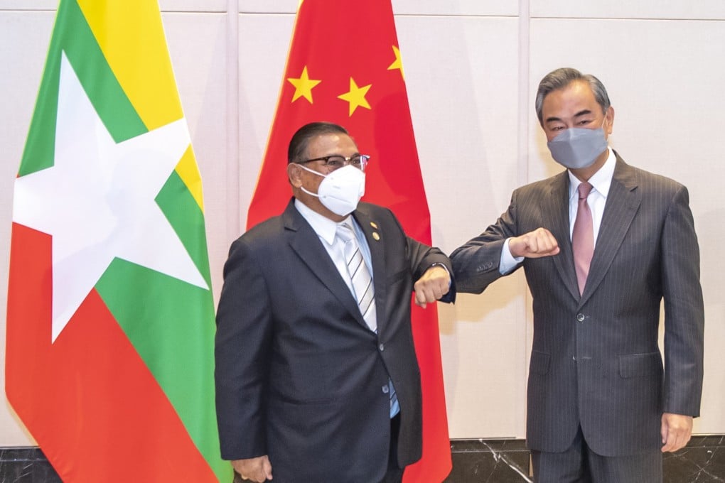 China’s Foreign Minister Wang Yi (right) bumps elbows with junta representative Wunna Maung Lwin at a June 8 meeting marking the 30th anniversary of formal relations between China and Asean. Photo: Xinhua