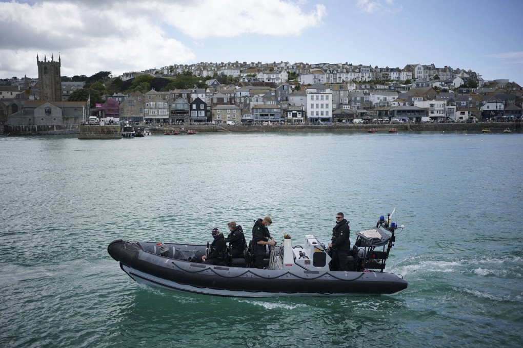 Police patrol the harbour in St Ives, Cornwall, England ahead of the G7 summit that takes place in nearby Carbis Bay. Photo: AP