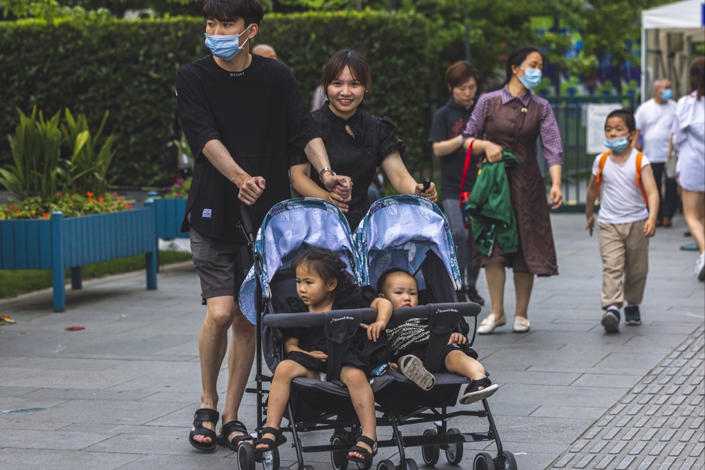 A couple push children in a stroller in Shanghai on June 1. Chinese mothers gave birth to 12 million babies last year, down from 14.65 million in 2019, marking an 18 per cent decline year on year. Photo: EPA-EFE