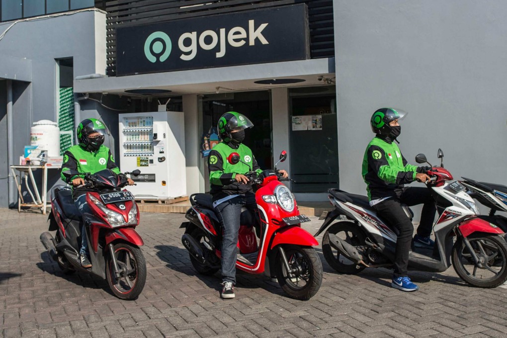 Gojek riders wait for delivery orders at a distribution centre in Surabaya. Photo: AFP