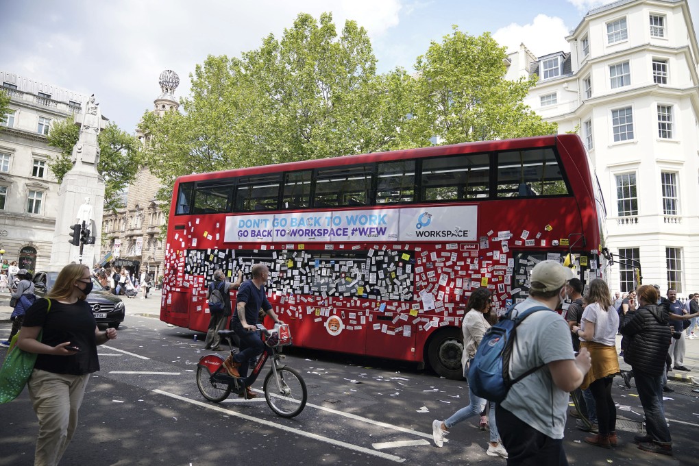 A bus is covered in anti-vaccine stickers near Trafalgar Square in London. Photo: PA via AP