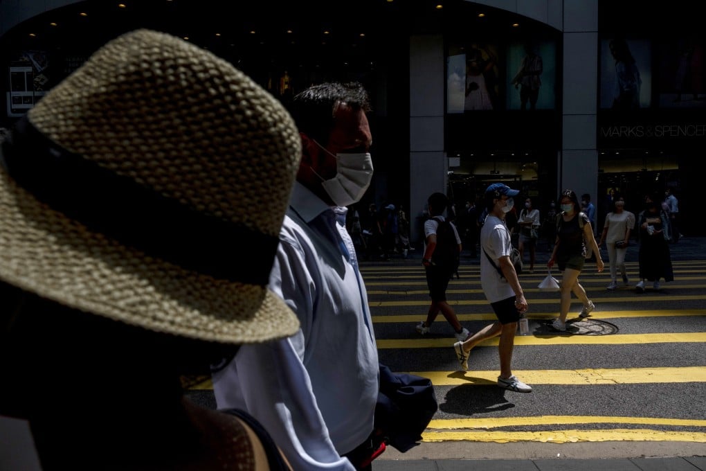 People walk past a pedestrian crossing during lunch hour in the Central district of Hong Kong, on June, 7. Photo: Bloomberg