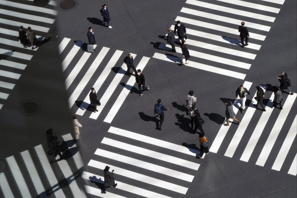 People use a pedestrian crossing in Tokyo on March 3. After a slow start, Japan’s vaccination campaign has started to take off. Photo: AP