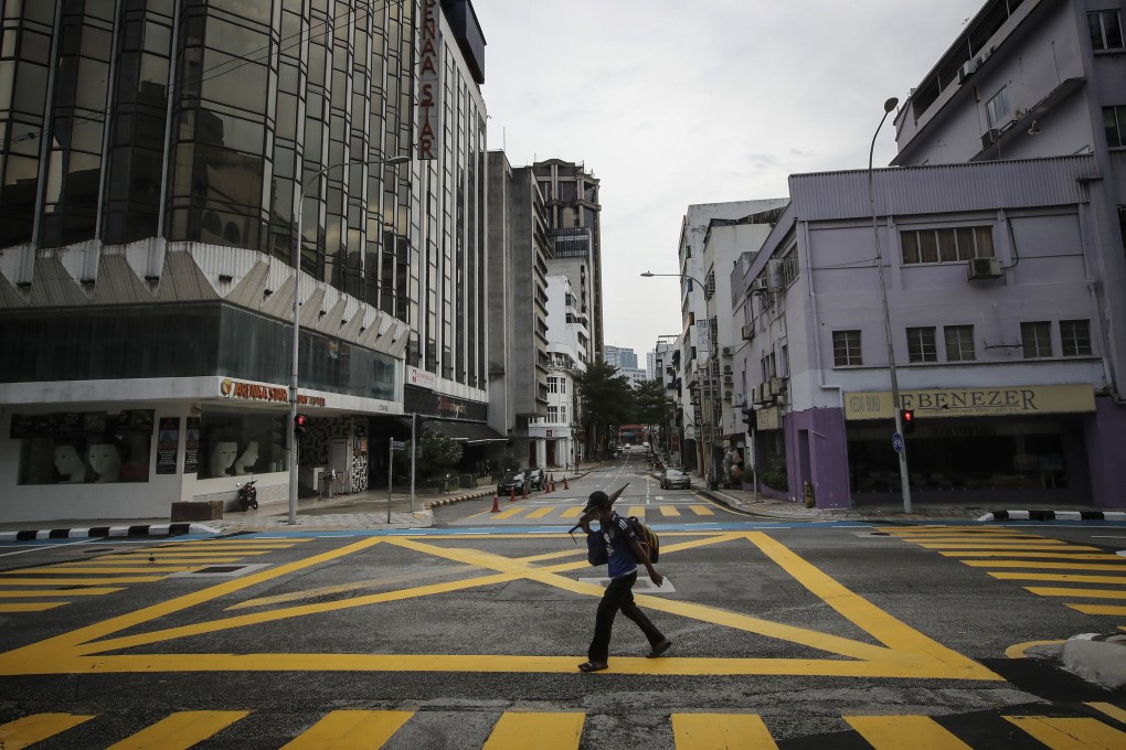 A man walks along a deserted street during a nationwide lockdown in Malaysia. Photo: SOPA Images via ZUMA Wire/dpa