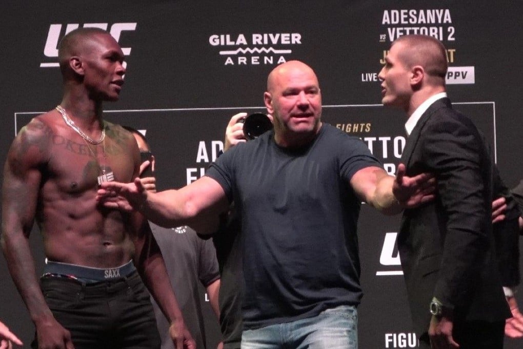 Security steps in to separate Marvin Vettori from Israel Adesanya (left). Photos: Drake Riggs