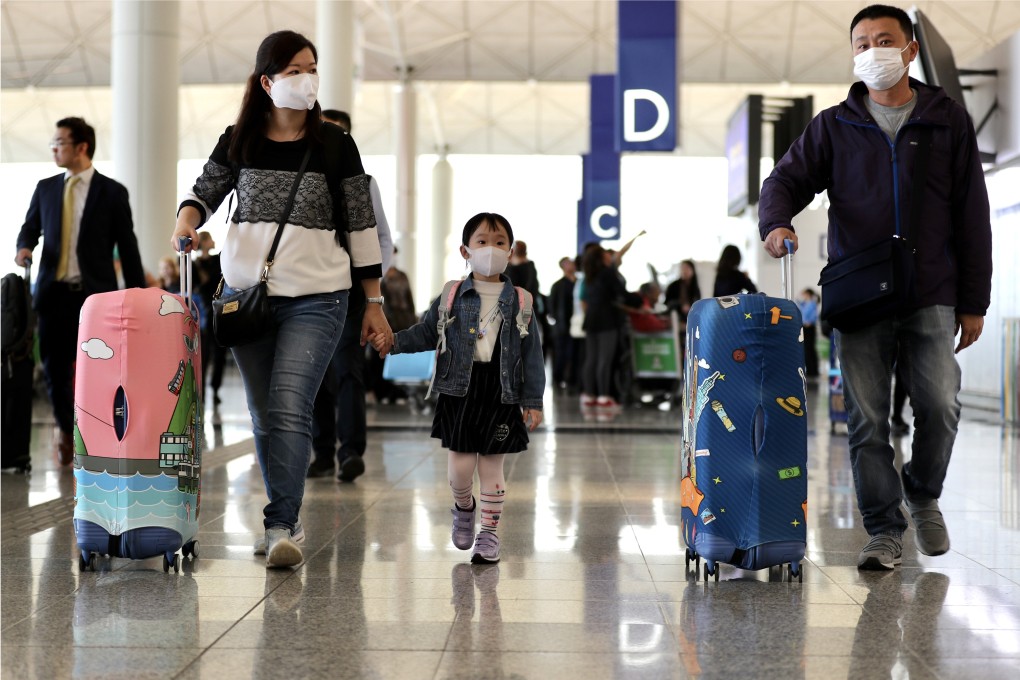 A family with a young child at the check-in halls of the Hong Kong International Airport. Photo: Bloomberg