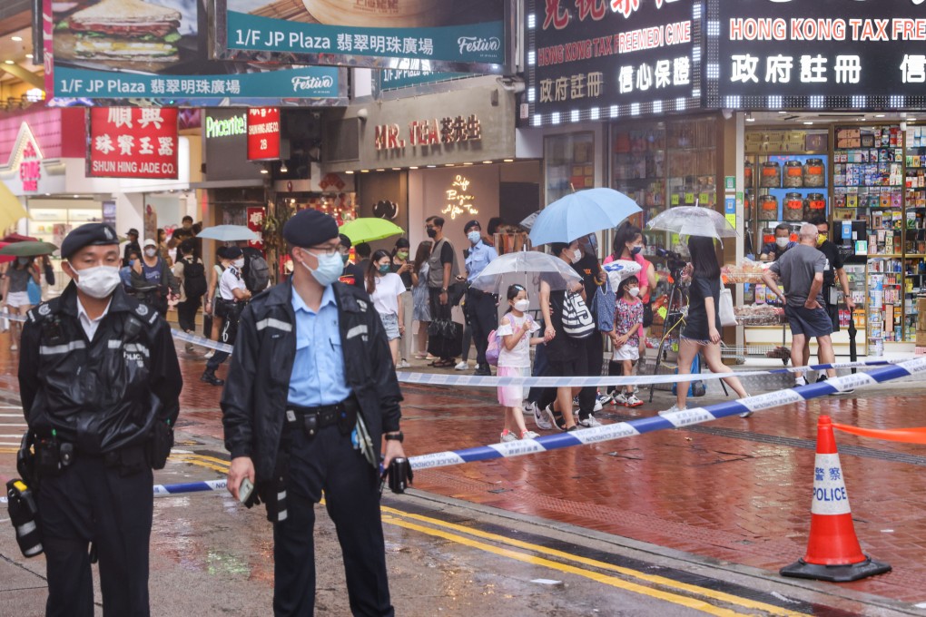 Shoppers in Hong Kong’s Causeway Bay shopping district walk past a police cordon on Saturday. Photo: Nora Tam