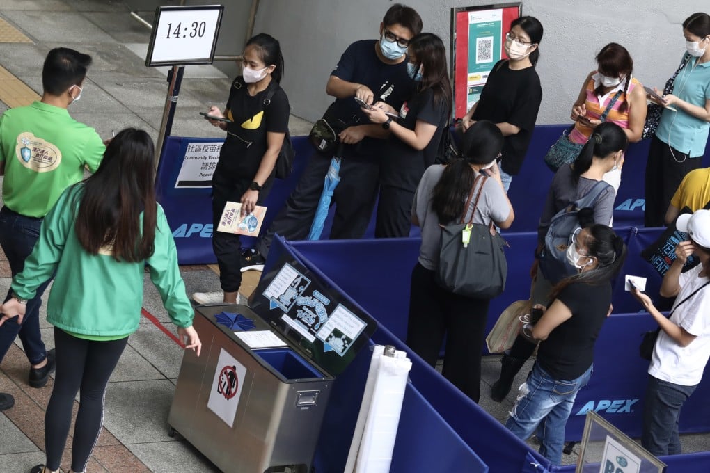 Residents queue for BioNTech vaccinations at Sun Yat Sen Memorial Park Sports Centre on Saturday. Photo: Jonathan Wong
