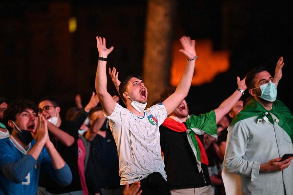 Italy fans watch the Euro 2020 football championship on a giant screen from an official fan zone at the Roman Forum in Rome, Italy on Friday. Photo: AFP