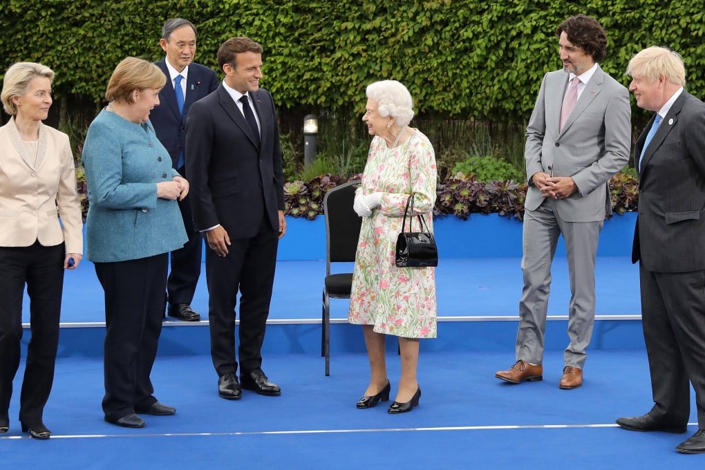 Britain’s Queen Elizabeth, centre. From left, the EU’s Ursula von der Leyen, Germany’s Angela Merkel, Japan’s Yoshihide Suga, France’s Emmanuel Macron, Canada’s Justin Trudeau and Britain’s Boris Johnson at the Eden Project in England, UK on Friday. Photo: AFP