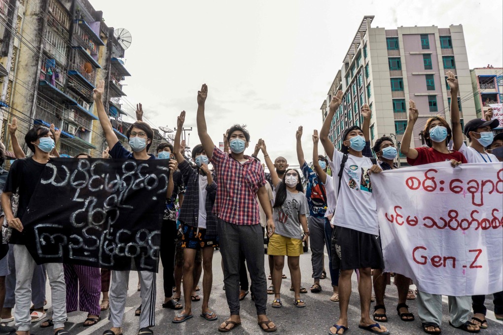 Protesters make the three-finger salute as they take part in a demonstration against the military coup in Yangon on June 13. Photo: AFP