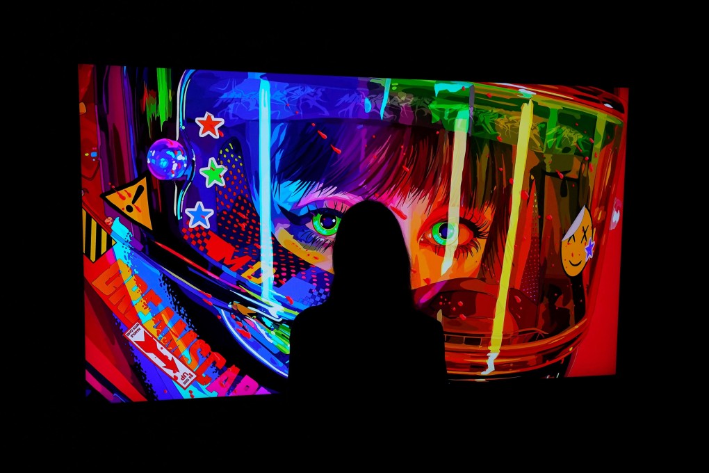 A woman looks at an NFT by Mad Dog Jones during a media preview on June 4, at Sotheby’s, for the Natively Digital: A Curated NFT Sale Online Auction. While the current NFT craze is predominantly focused on collectibles, NFTs can be practical tools aligning with the principles of decentralised finance. Photo: AFP