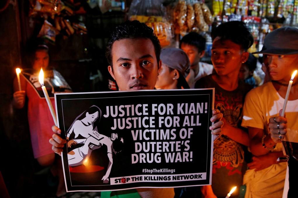 Protesters hold candles at the wake of a 17-year-old student who was killed during President Rodrigo Duterte’s crackdown on drugs. Photo: Reuters