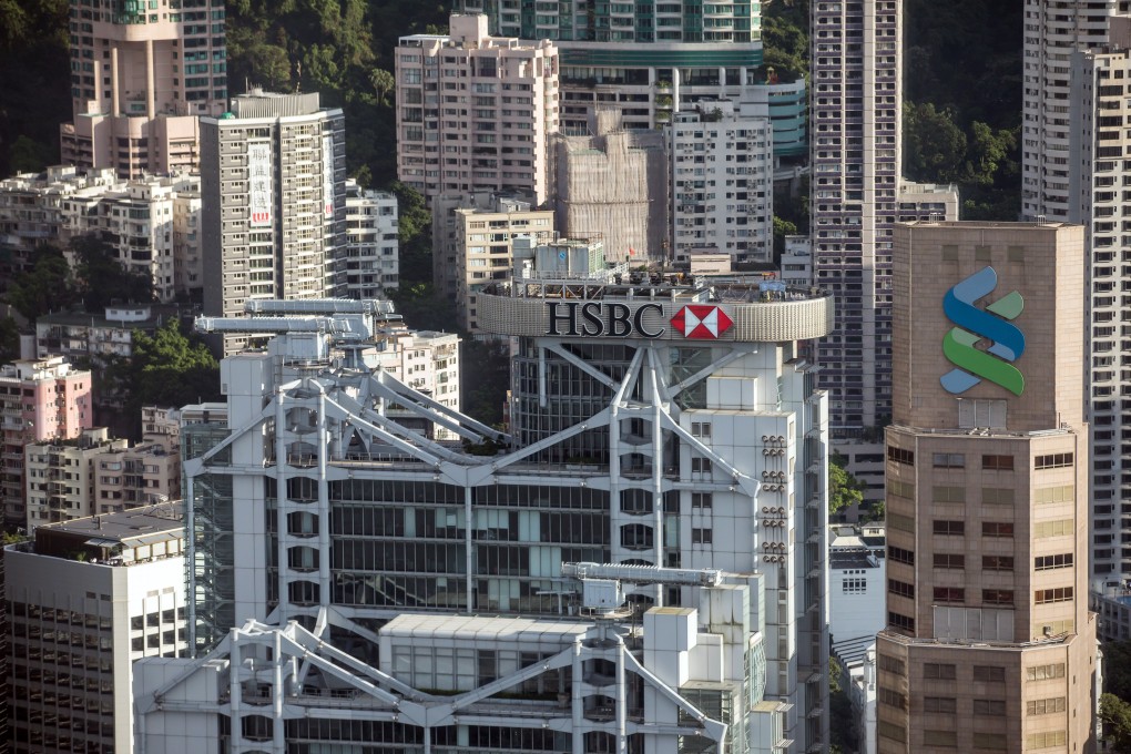 Low interest rates and economic uncertainty as a result of the coronavirus pandemic will continue to weigh on the bottom lines in 2021 of Hong Kong banks, including HSBC and Standard Chartered. Photo: Bloomberg