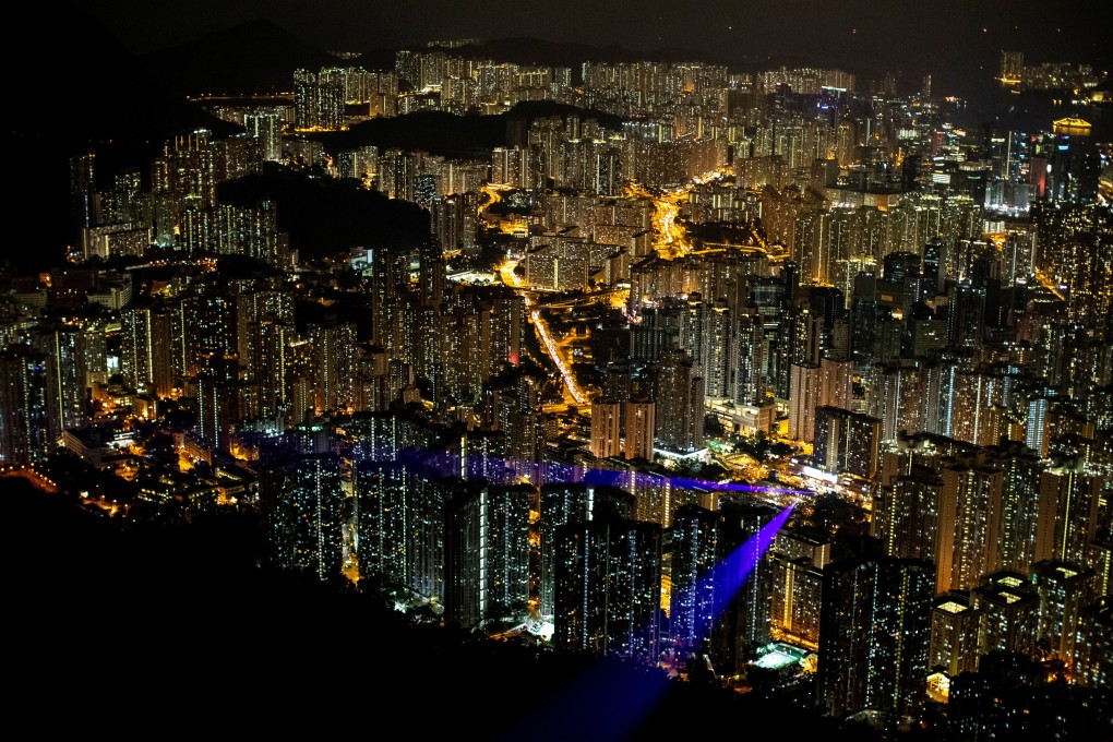 Laser beams are seen coming out of residential buildings in Kowloon, as anti-government protesters gather on Lion Rock in Hong Kong in September 2019. Beijing has designated Hong Kong’s housing crisis as the root cause of the protests. Photo: Reuters