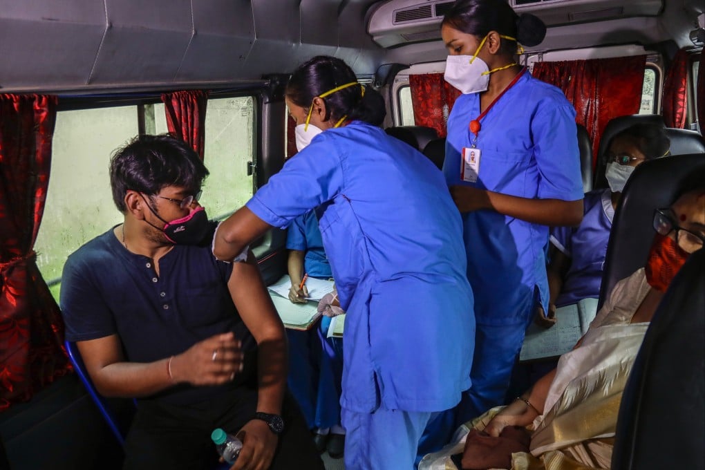 An India health worker administers shots during a drive-in vaccination program in Kolkata. Photo: AP