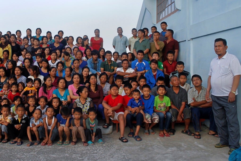 Family members of Ziona Chana pose outside their residence in Baktawng village in the northeastern Indian state of Mizoram in 2011. Photo: Reuters