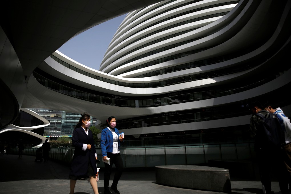 People wearing face masks are seen during lunch hour at the Galaxy Soho office buildings in Beijing, following the Covid-19 outbreak. Photo: Reuters