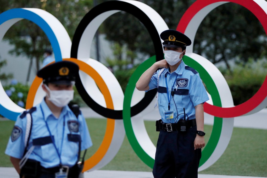 Security officers guard next to the Olympic Rings monument during an anti-Olympics rally outside the Japan Olympic Committee (JOC) headquarters near the National Stadium in Tokyo in June. Photo: Reuters