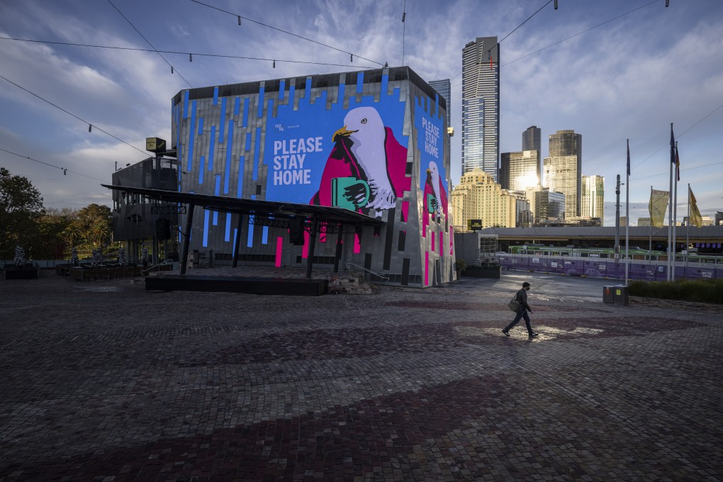 A lone person walks through Melbourne’s usually bustling Federation Square amid the city’s Covid-19 lockdown. Photo: AAP