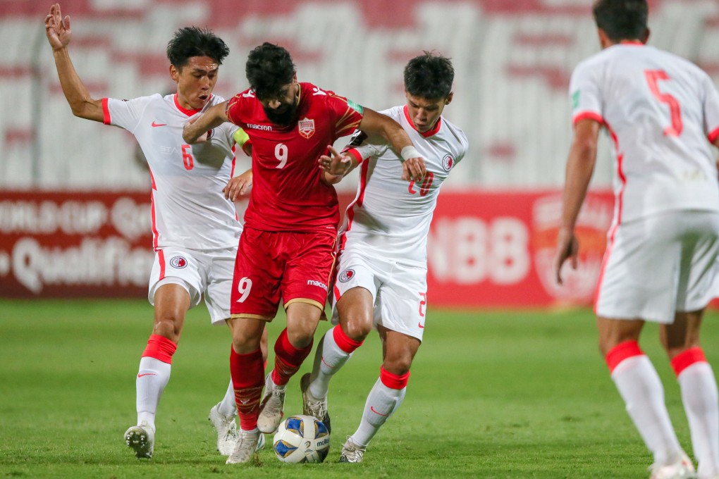 Hong Kong captain Huang Yang (left) and Yu Wai-lim try to stop Hashim Sayed Isa of Bahrain. Photo: HKFA