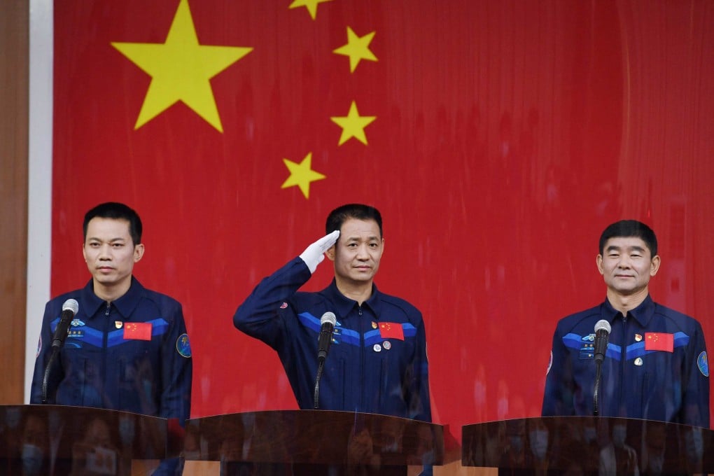 Astronauts (from left) Tang Hongbo, Nie Haisheng and Liu Boming, the first crew for China’s new space station, at a press briefing on Wednesday. Photo: AFP