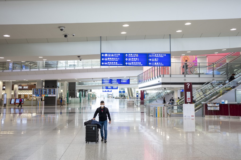A traveller wearing a protective mask walks through the arrivals hall at Hong Kong International Airport in Hong Kong in March 2020. Photo: Bloomberg