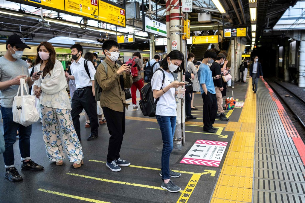 Passengers wait for a train at Shinjuku station in Tokyo. Photo: AFP