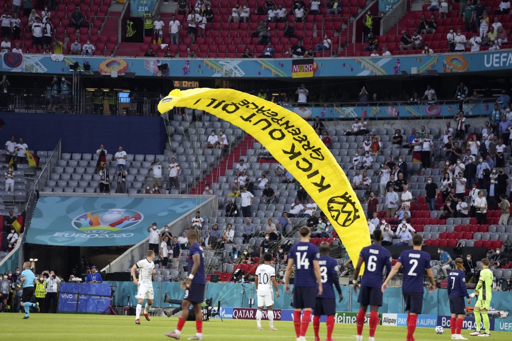 A Greenpeace paraglider lands on the pitch before the Euro 2020 football match between France and Germany at the Allianz Arena in Munich, Germany on Tuesday. Photo: AP