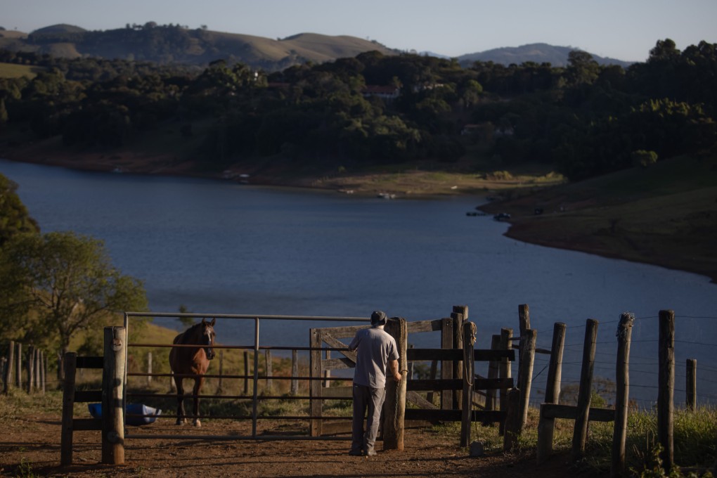 A farm worker at the Jacarei Reservoir, near Joanopolis, Brazil, on June 13. In Brazil, forecasts for consumer prices are being revised upwards, not downwards. Part of the problem is that a once-in-a-century drought has pushed up electricity prices – something that is beyond the control of central banks. Photo: Bloomberg