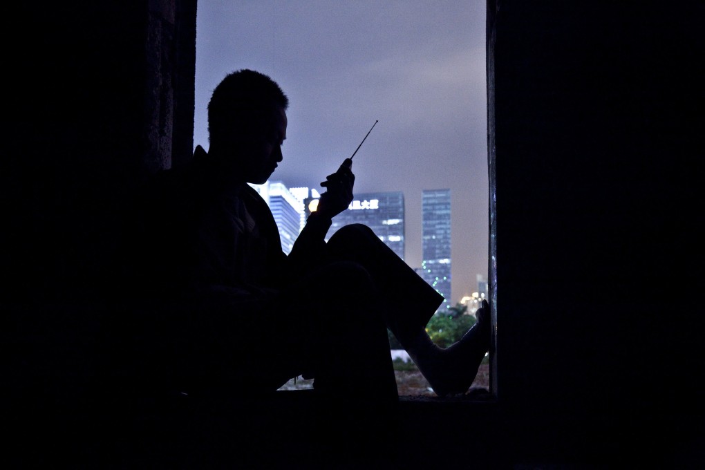 A young man listens to the radio in his flat in Shenzhen in 2010. Today, young Chinese fed up with gruelling work hours, conspicuous consumption and skyrocketing home prices are protesting by doing the bare minimum, a lifestyle called “lying flat”. Photo: Getty Images