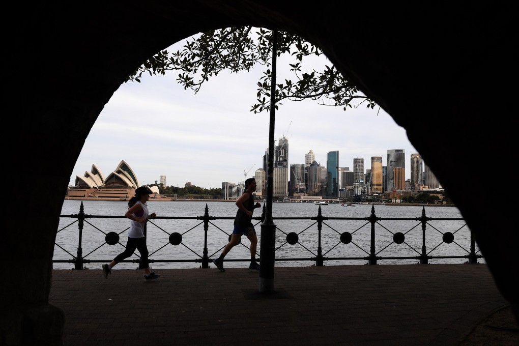 People jog in view of the city skyline in Sydney, Australia, September 2, 2020. Photo: EPA-EFE