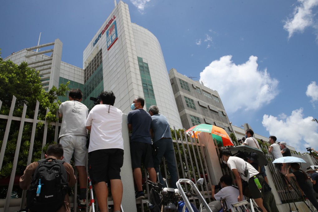 Reporters wait outside the Apple Daily offices in Tseung Kwan O while police search the newsroom. Photo: Winson Wong