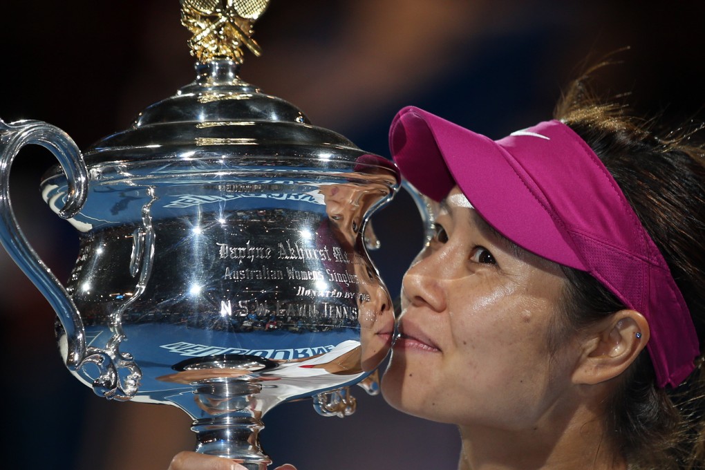 Li Na kisses the championship trophy after defeating Dominika Cibulkova of Slovakia at the 2014 Australian Open. Photo: AP