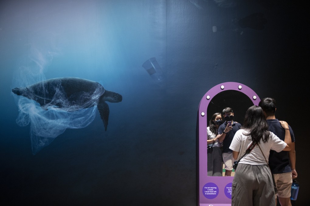 Visitors take photos at an interactive section of the ‘Planet or Plastic?’ exhibition highlighting the impact of marine pollution, at the ArtScience Museum in Singapore on September 16, 2020. Photo: EPA-EFE