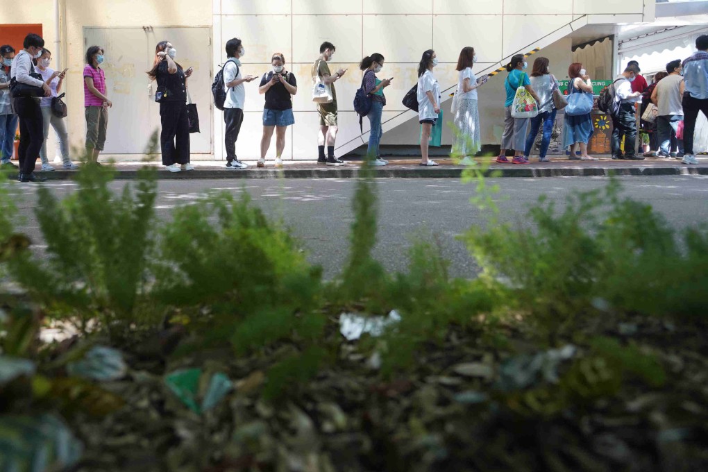 Hong Kong residents queue for their vaccine doses at Lai Chi Kok Park Sports Centre on June 16. Photo: Winson Wong