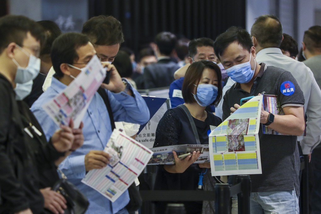 Potential homebuyers line up at New World Development’s sales office in Tsuen Wan to buy flats at The Pavilia Farm. Photo: Jonathan Wong